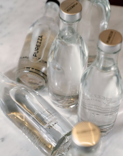 Branded Purezza reusable water bottle on a restaurant table